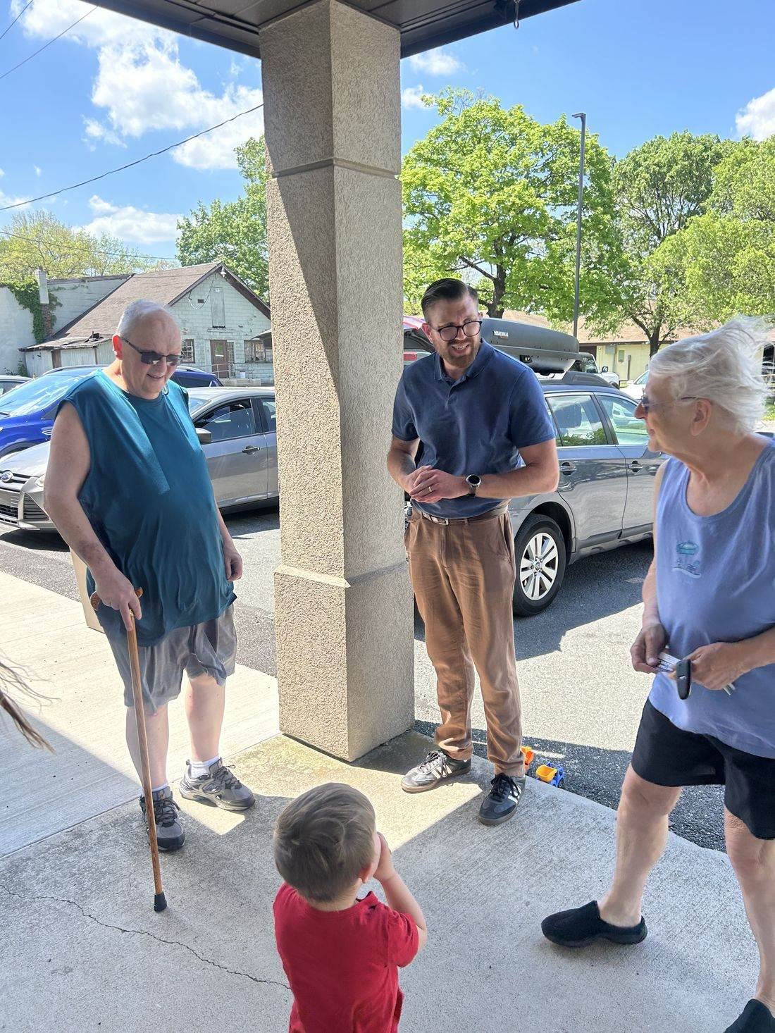 Christian Bartulovich talking with residents in the community