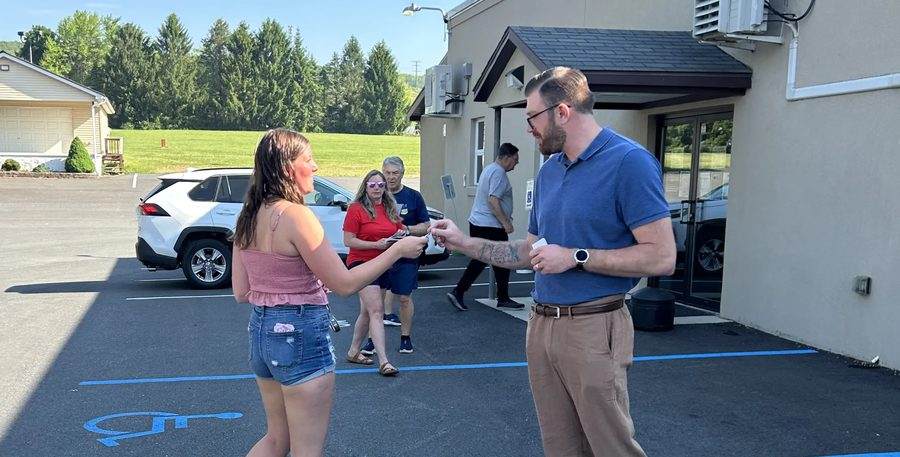 Christian Bartulovich talking with a voter